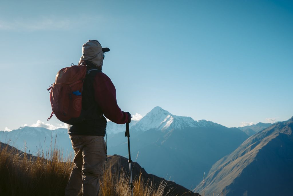 Turista admirando os Andes peruanos na rota de Ancascocha.